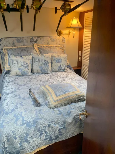 Lolly Yacht Photos Pics 1985 Ocean Yachts 55 Super Sport bedroom with floral bedding and fishing rods.