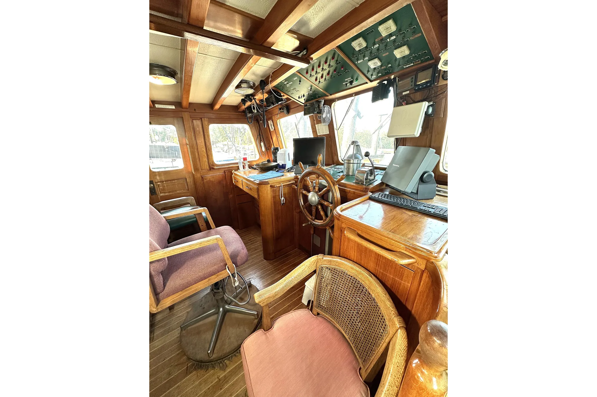 Vintage 1971 Southern Marine MALAHIDE Pilothouse LRC interior with wooden helm and navigation equipment.