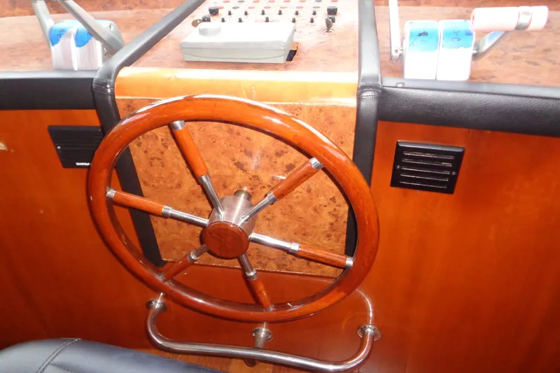 (project Boat) 1995 Azimut 78ultra @ixtapa-mexico Yacht Photos Pics Steering wheel of 1995 Azimut 78 Ultra Motoryacht, featuring wood and metal accents.