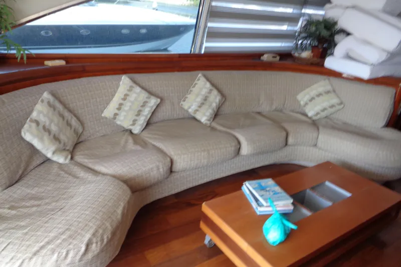(project Boat) 1995 Azimut 78ultra @ixtapa-mexico Yacht Photos Pics Luxurious interior of 1995 Azimut 78 Ultra Motoryacht with curved sofa and wooden table.