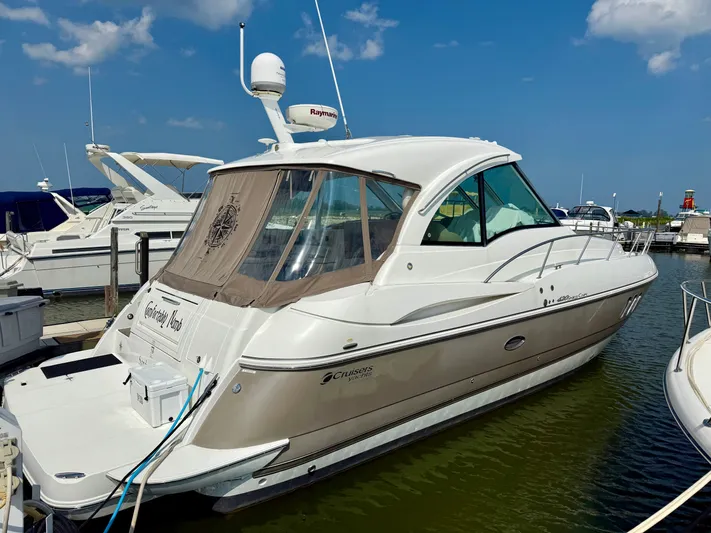  Yacht Photos Pics 2009 Cruisers Yachts 420 Coupe docked at marina under blue sky.