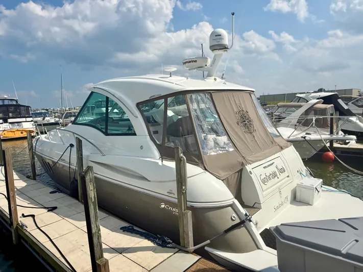  Yacht Photos Pics 2009 Cruisers Yachts 420 Coupe docked at marina under blue sky.