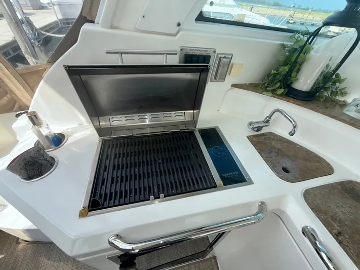  Yacht Photos Pics Outdoor grill and sink on 2009 Cruisers Yachts 420 Coupe, featuring sleek design and modern amenities.