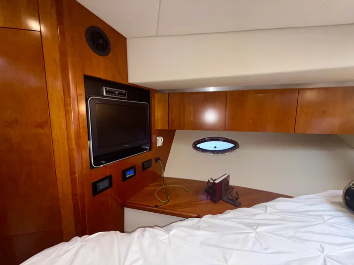  Yacht Photos Pics Interior cabin of 2009 Cruisers Yachts 420 Coupe with wood paneling and TV.