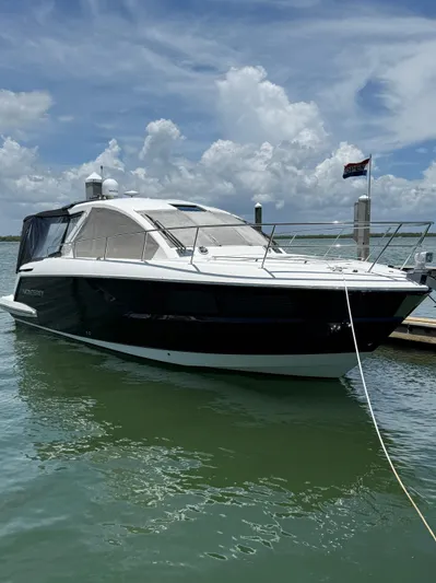  Yacht Photos Pics 2016 Monterey 360 Sport Coupe docked under a cloudy sky.