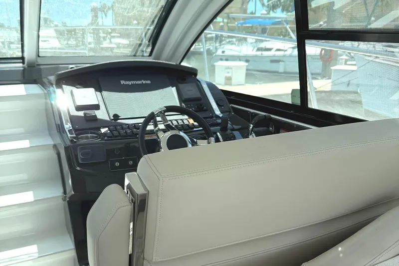  Yacht Photos Pics 2016 Monterey 360 Sport Coupe helm with Raymarine navigation system, docked at marina.