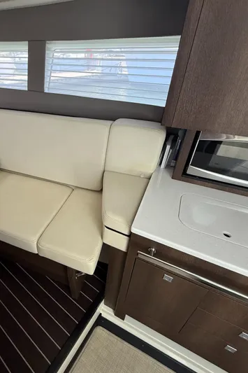  Yacht Photos Pics Interior of a 2016 Monterey 360 Sport Coupe with beige seating and modern kitchenette.