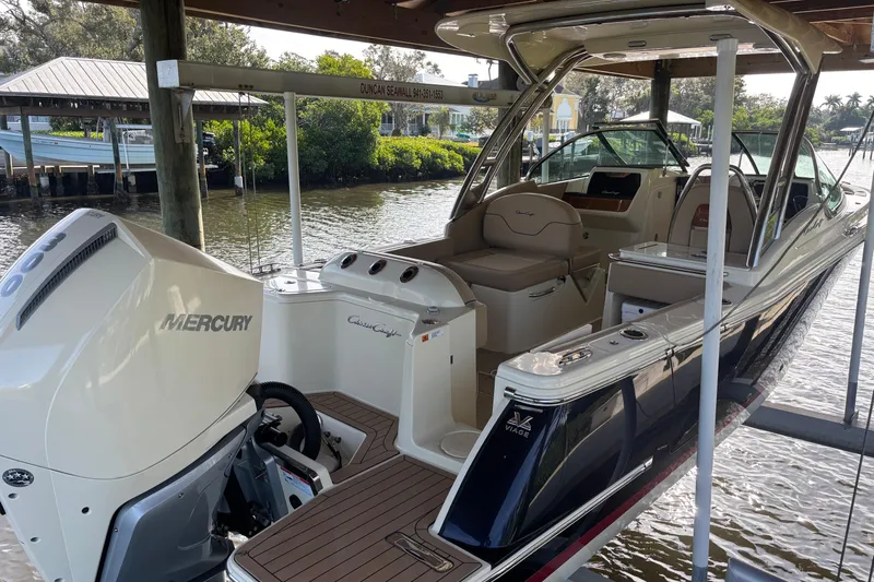  Yacht Photos Pics 2023 Chris-Craft Calypso 24 boat with Mercury engine docked in a scenic marina.