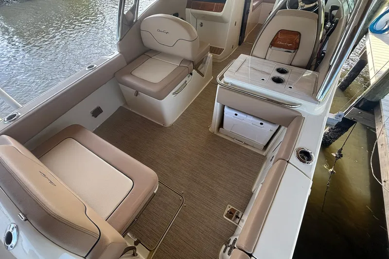  Yacht Photos Pics 2023 Chris-Craft Calypso 24 boat interior with beige seating and storage compartments.