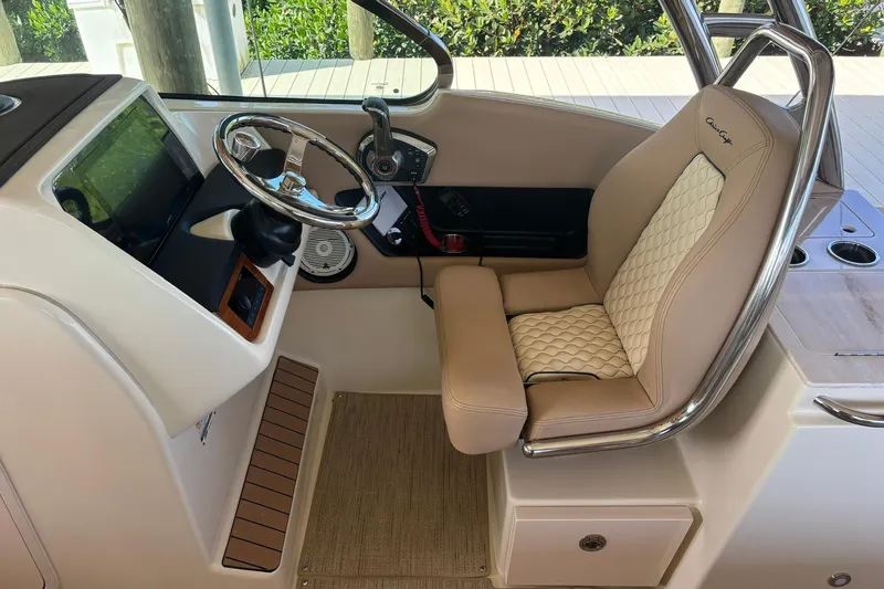  Yacht Photos Pics 2023 Chris-Craft Calypso 24 helm with luxurious seating and modern controls.