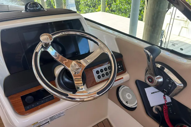  Yacht Photos Pics 2023 Chris-Craft Calypso 24 helm with steering wheel and control panel.