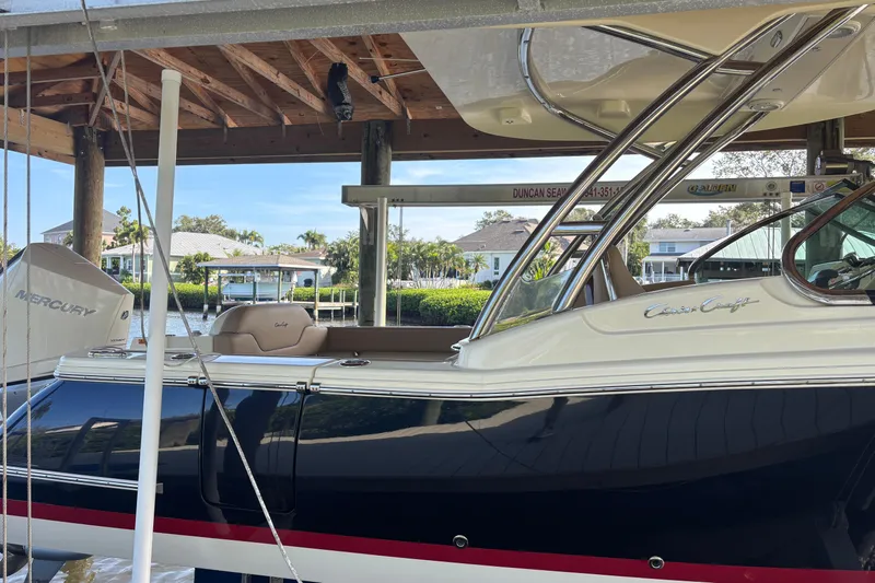  Yacht Photos Pics 2023 Chris-Craft Calypso 24 boat docked under wooden shelter.