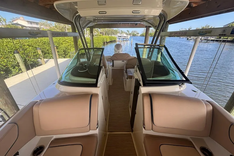  Yacht Photos Pics 2023 Chris-Craft Calypso 24 boat interior with luxurious seating and waterfront view.