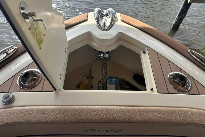  Yacht Photos Pics 2023 Chris-Craft Calypso 24 anchor compartment with open hatch, showcasing teak deck details.
