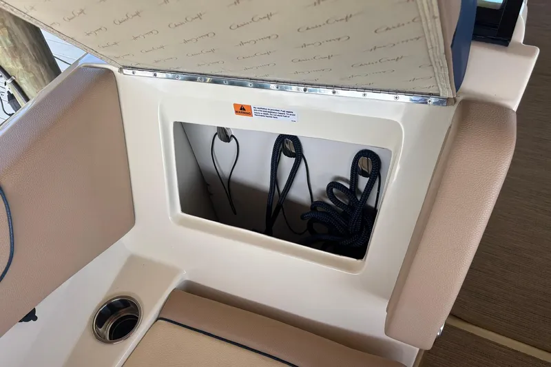  Yacht Photos Pics 2023 Chris-Craft Calypso 24 storage compartment with ropes and cup holder.