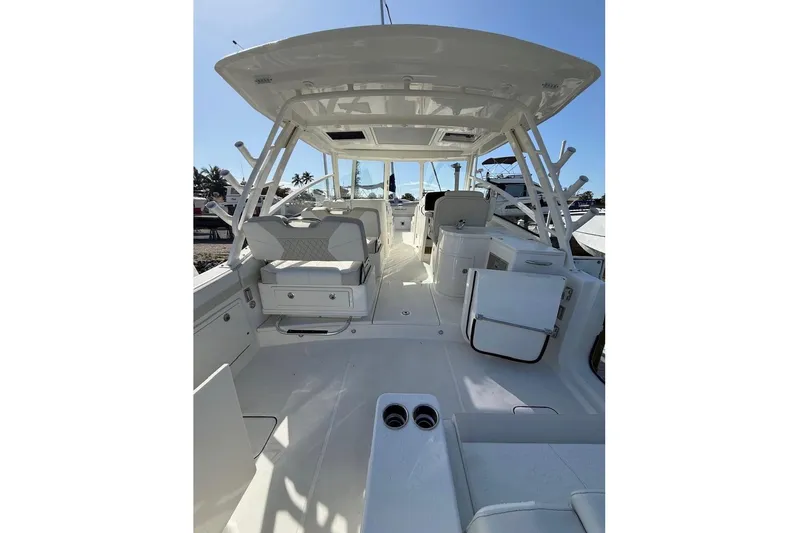 57694 325dc Yacht Photos Pics 2026 World Cat 325 DC boat interior with seating and storage, under a clear blue sky.