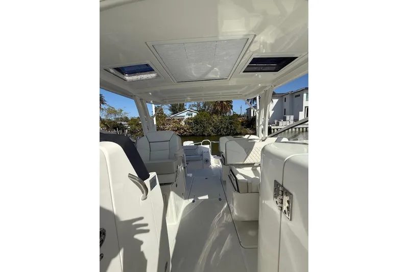 57694 325dc Yacht Photos Pics Interior view of 2026 World Cat 325 DC boat, featuring sleek white seating and modern design.