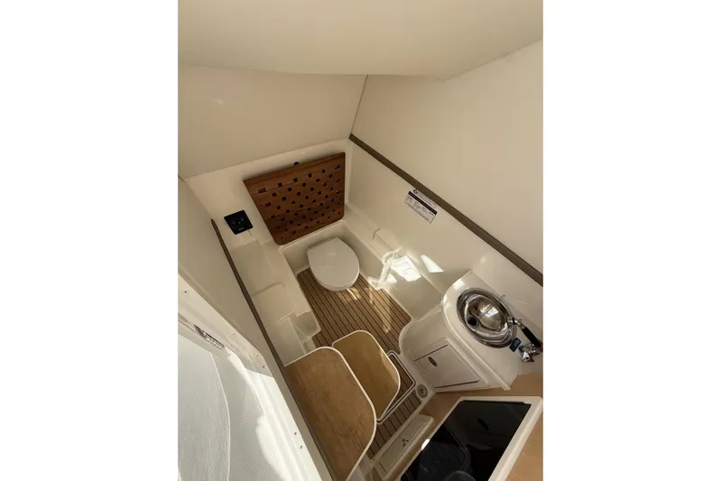 57694 325dc Yacht Photos Pics 2026 World Cat 325 DC boat interior with toilet, sink, and wooden flooring.