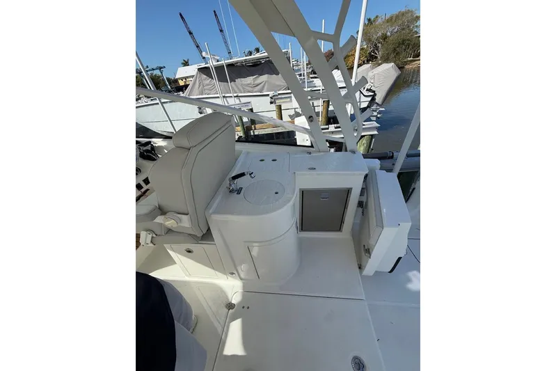 57694 325dc Yacht Photos Pics 2026 World Cat 325 DC boat interior with seating and storage at a marina.