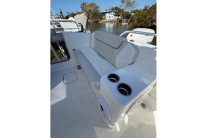 57694 325dc Yacht Photos Pics 2026 World Cat 325 DC boat interior with white seating and cup holders.