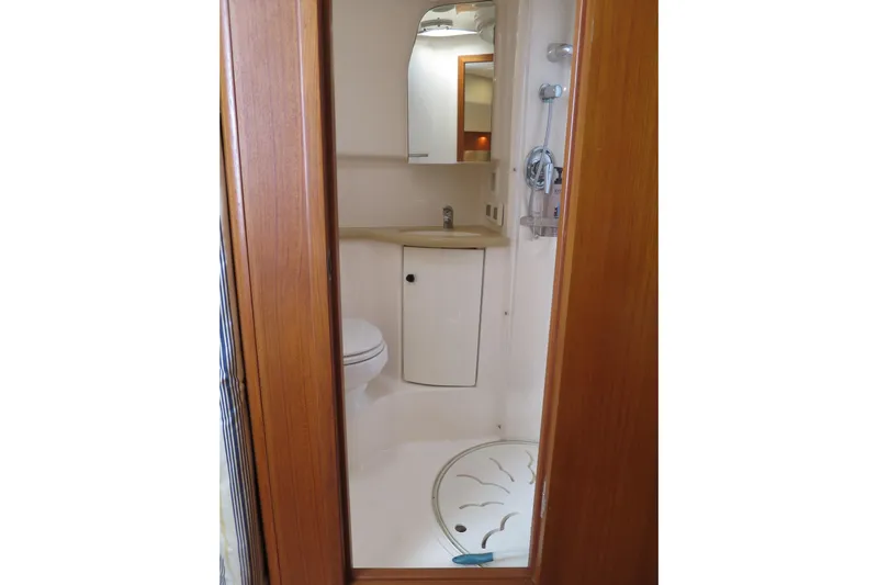 Queen Angela Yacht Photos Pics Bathroom interior of 2004 Tiara Yachts 3800 Open, featuring shower and sink.