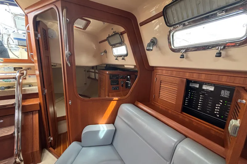 Moondance Yacht Photos Pics 2007 Island Packet 370 yacht interior with wood paneling and control panels.