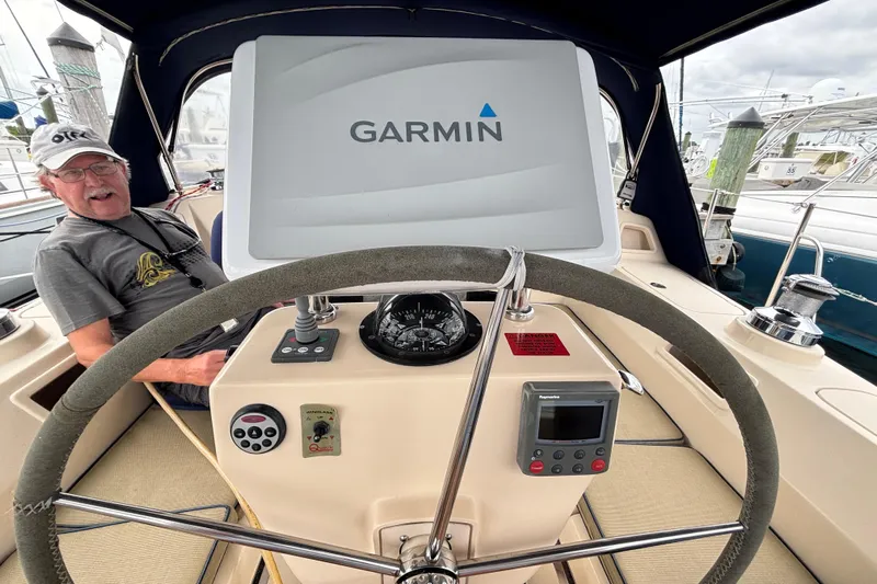 Moondance Yacht Photos Pics 2007 Island Packet 370 sailboat cockpit with Garmin navigation system and steering wheel.