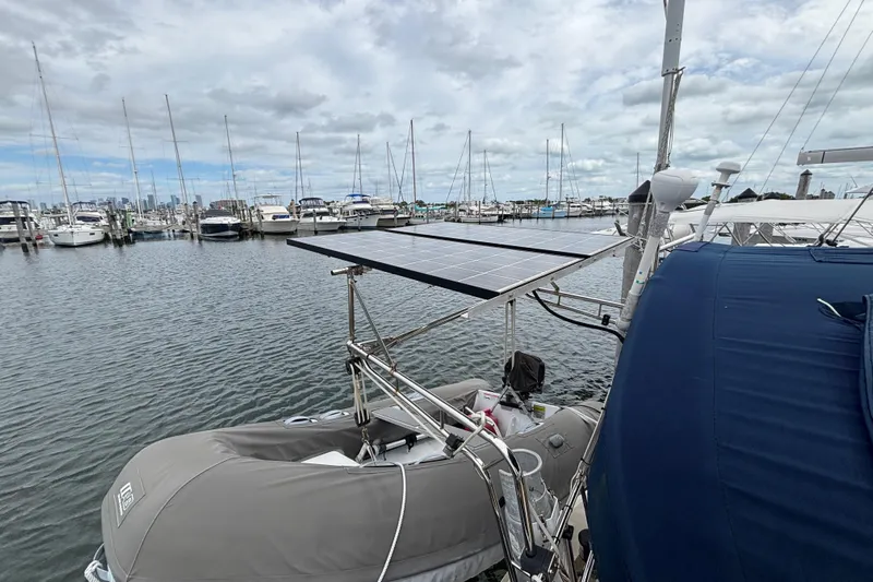 Moondance Yacht Photos Pics Sailboat Island Packet 370 (2007) with solar panels docked at marina.
