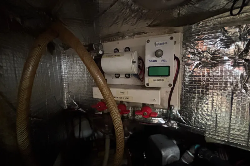 Moondance Yacht Photos Pics Engine compartment of a 2007 Island Packet 370 sailboat, featuring control panel and wiring.