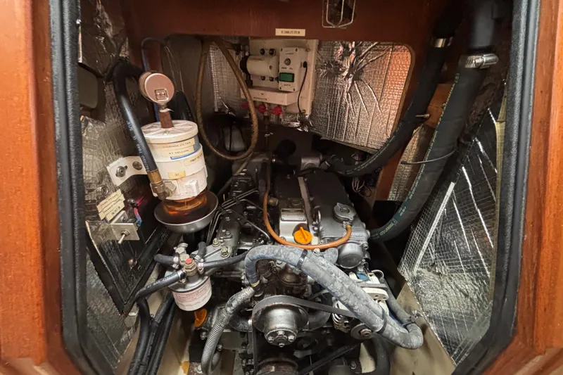 Moondance Yacht Photos Pics Engine compartment of a 2007 Island Packet 370 sailboat, showcasing mechanical components and insulation.