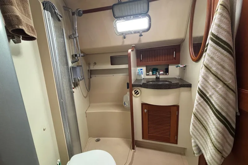Moondance Yacht Photos Pics 2007 Island Packet 370 yacht bathroom with shower, sink, and storage cabinets.