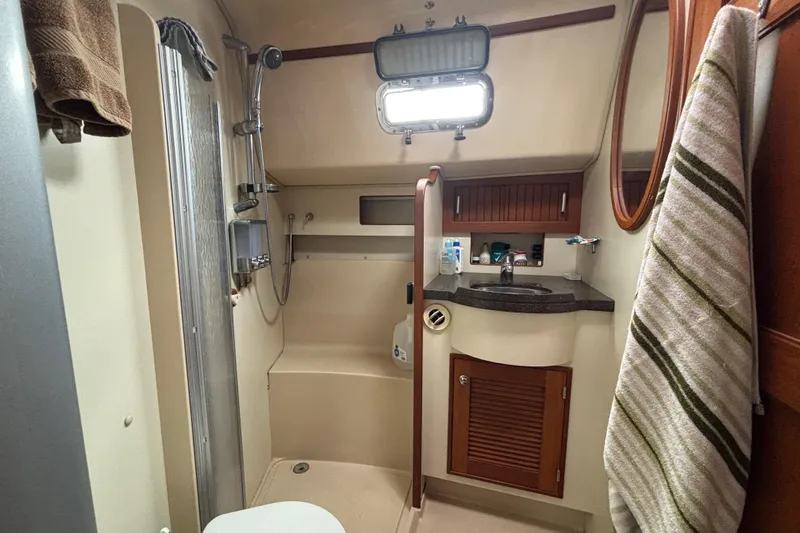 Moondance Yacht Photos Pics 2007 Island Packet 370 yacht bathroom with shower, sink, and storage cabinets.