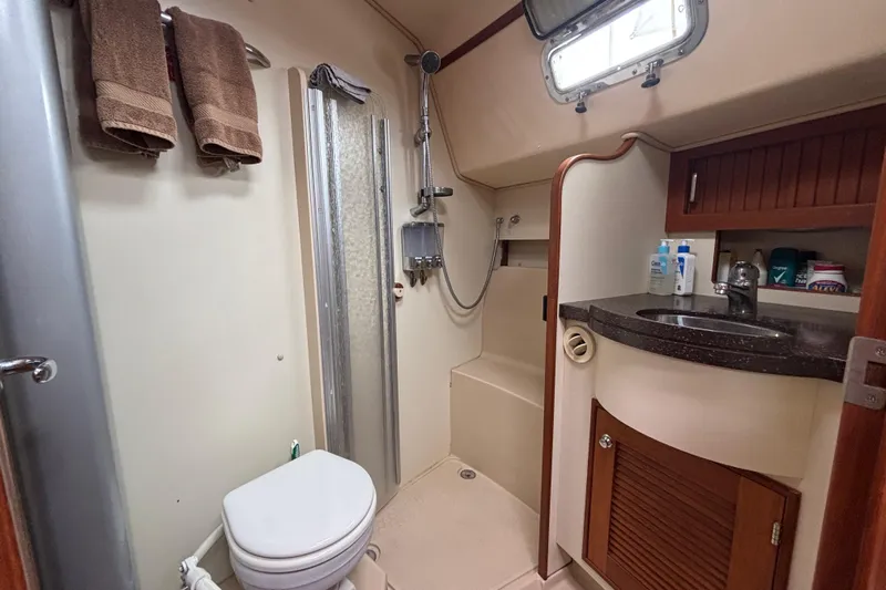 Moondance Yacht Photos Pics 2007 Island Packet 370 yacht bathroom with shower, sink, and storage cabinets.