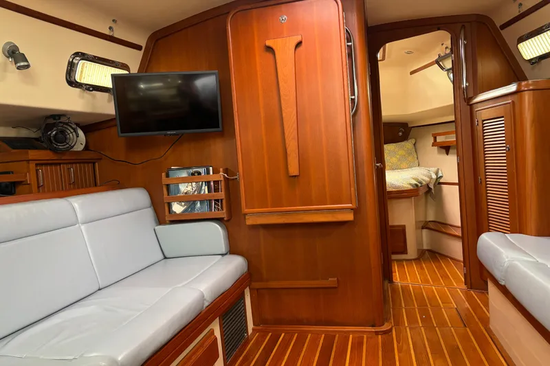 Moondance Yacht Photos Pics Interior of 2007 Island Packet 370 sailboat with wood finish and cozy seating.