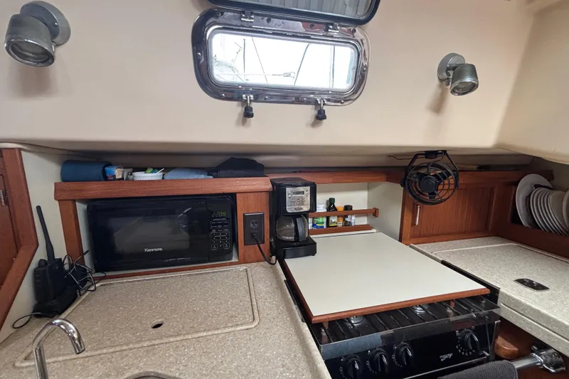 Moondance Yacht Photos Pics 2007 Island Packet 370 yacht kitchen with microwave, coffee maker, and stove.