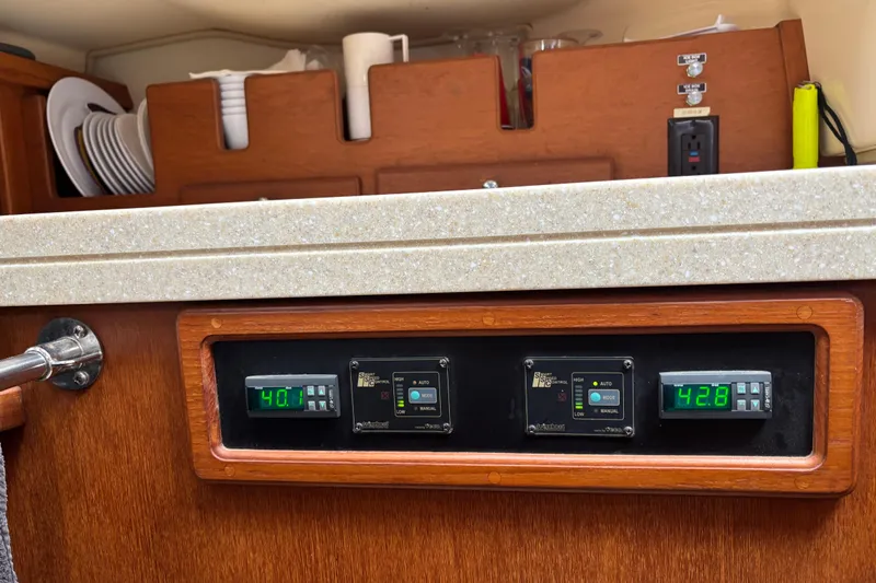 Moondance Yacht Photos Pics Interior of 2007 Island Packet 370 yacht with control panel and storage.