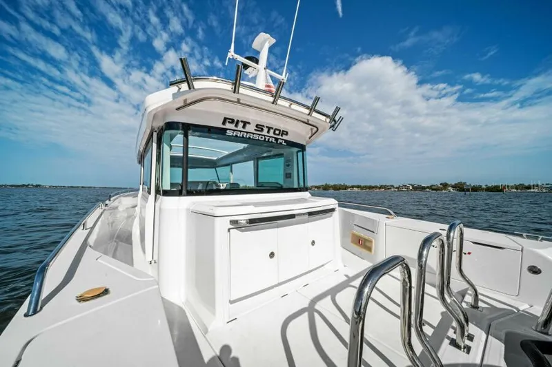  Yacht Photos Pics 2022 Axopar 37 Cross Cabin boat on water under blue sky.