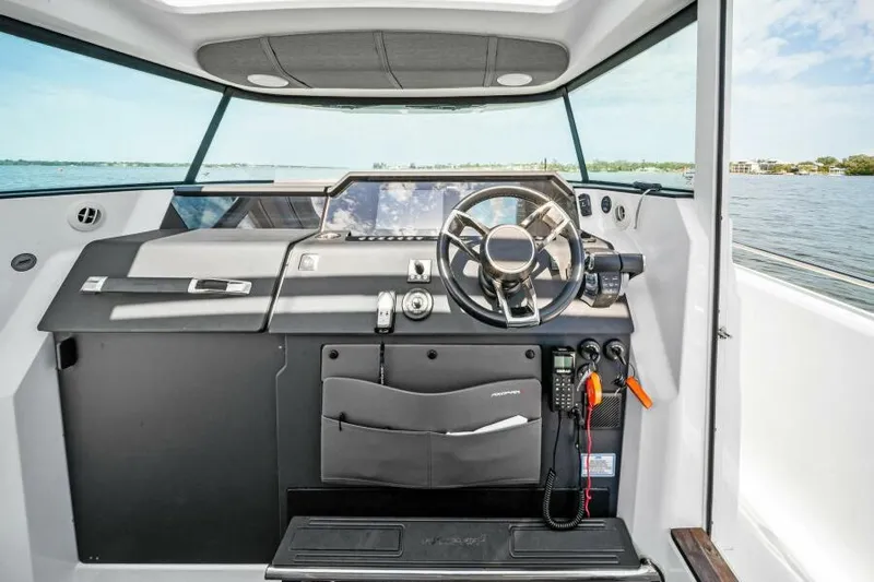  Yacht Photos Pics 2022 Axopar 37 Cross Cabin helm with modern controls and panoramic view.