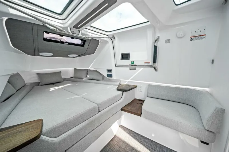  Yacht Photos Pics 2022 Axopar 37 Cross Cabin interior with modern seating and skylights.