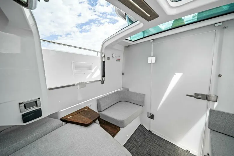  Yacht Photos Pics 2022 Axopar 37 Cross Cabin interior with modern seating and skylight.