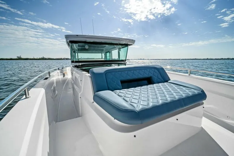  Yacht Photos Pics 2022 Axopar 37 Cross Cabin boat with blue seating on open water.