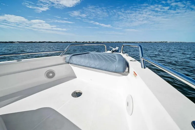  Yacht Photos Pics 2022 Axopar 37 Cross Cabin boat on open water under blue sky.