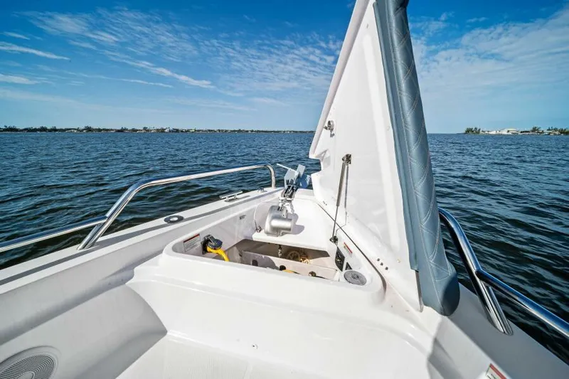  Yacht Photos Pics Axopar 37 Cross Cabin 2022 boat with open storage compartment on calm water.