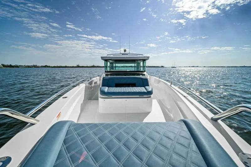  Yacht Photos Pics 2022 Axopar 37 Cross Cabin boat on open water under a clear blue sky.