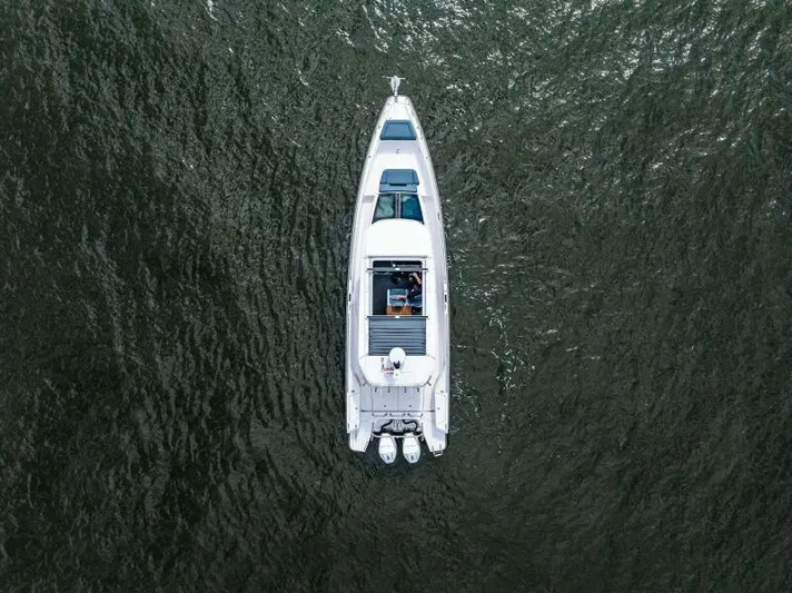  Yacht Photos Pics Top view of 2022 Axopar 37 Cross Cabin boat on open water.