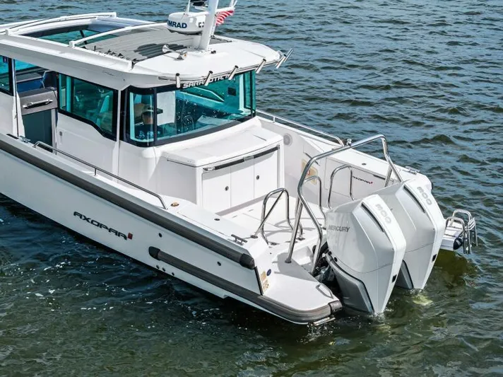  Yacht Photos Pics 2022 Axopar 37 Cross Cabin boat on water, featuring dual outboard engines.