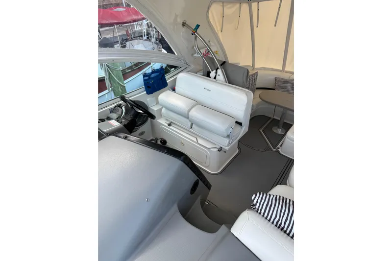  Yacht Photos Pics 2005 Cruisers Yachts 420 Express interior with helm, seating, and striped cushions.