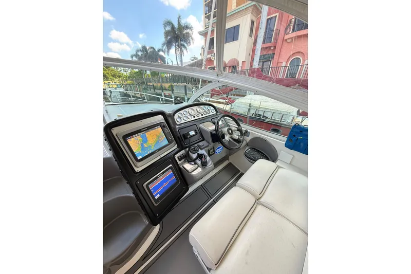  Yacht Photos Pics 2005 Cruisers Yachts 420 Express helm with navigation screens and steering wheel.
