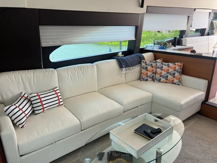 2024 Refit Yacht Photos Pics Luxurious interior of 2011 Hatteras 60 Motor Yacht with white leather sofa and decorative pillows.