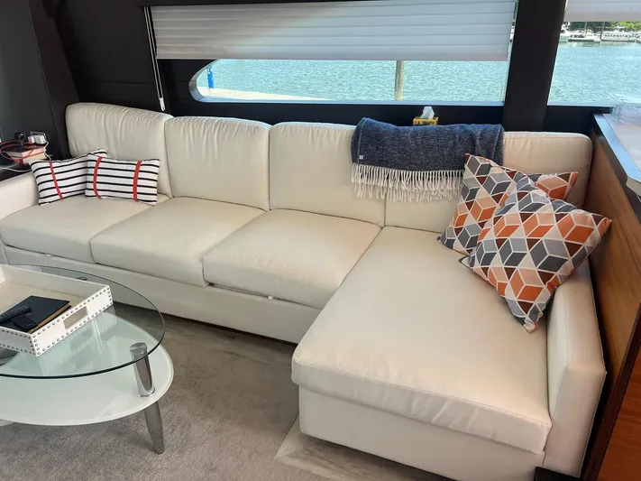 2024 Refit Yacht Photos Pics Luxurious interior of 2011 Hatteras 60 Motor Yacht with white sofa and decorative pillows.